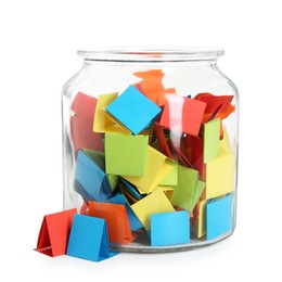 Photo of Many colorful paper pieces in glass jar isolated on white