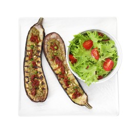 Photo of Slices of grilled eggplant with sun dried tomatoes, pesto and salad isolated on white, top view