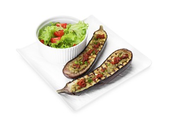 Photo of Slices of grilled eggplant with sun dried tomatoes, pesto and salad isolated on white