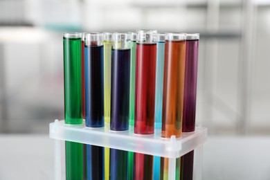 Photo of Test tubes with color liquids in laboratory, closeup