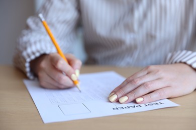 Photo of Student filling out multiple choice test at table, closeup. Passing exam