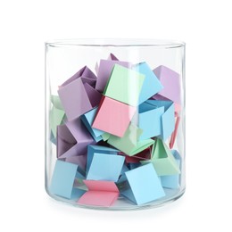 Photo of Many colorful paper pieces in glass isolated on white