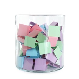 Photo of Many colorful paper pieces in glass isolated on white