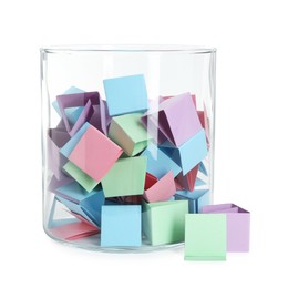 Photo of Many colorful paper pieces in glass isolated on white