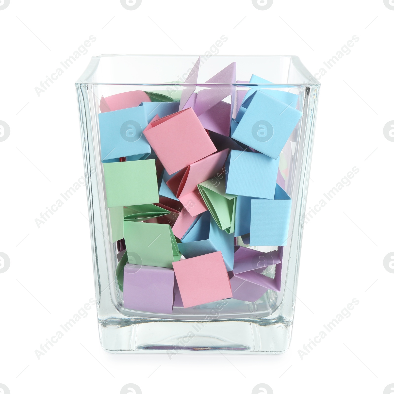 Many colorful paper pieces in glass isolated on white Photo of Many colorful paper pieces in glass isolated on white