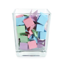 Photo of Many colorful paper pieces in glass isolated on white