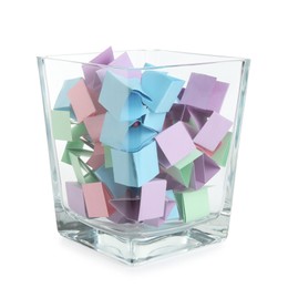 Photo of Many colorful paper pieces in glass isolated on white