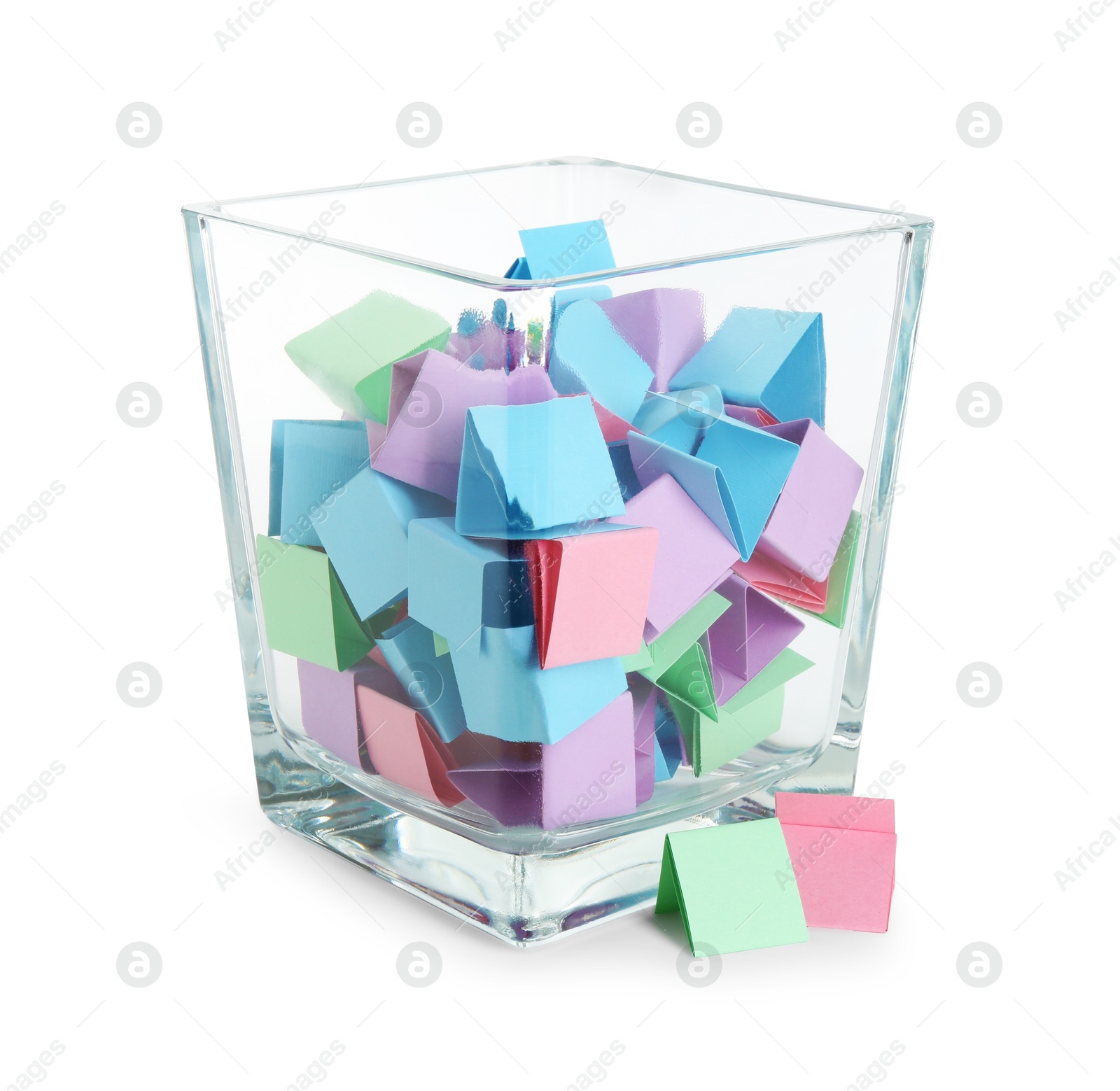 Many colorful paper pieces in glass isolated on white Photo of Many colorful paper pieces in glass isolated on white