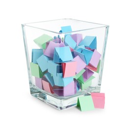 Photo of Many colorful paper pieces in glass isolated on white