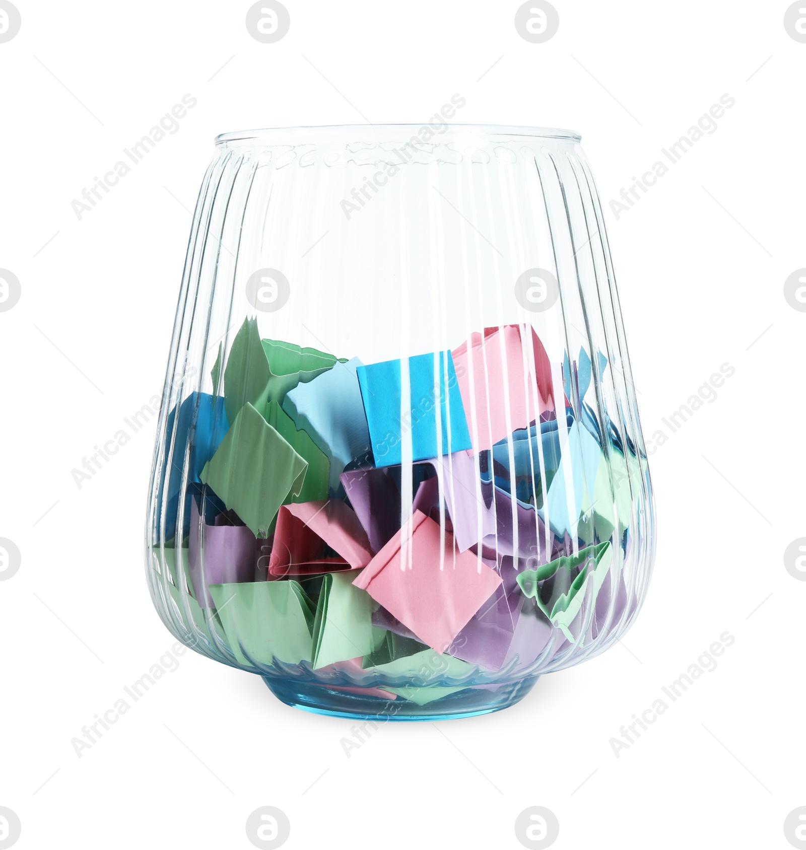 Many colorful paper pieces in glass isolated on white Photo of Many colorful paper pieces in glass isolated on white
