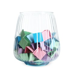 Photo of Many colorful paper pieces in glass isolated on white