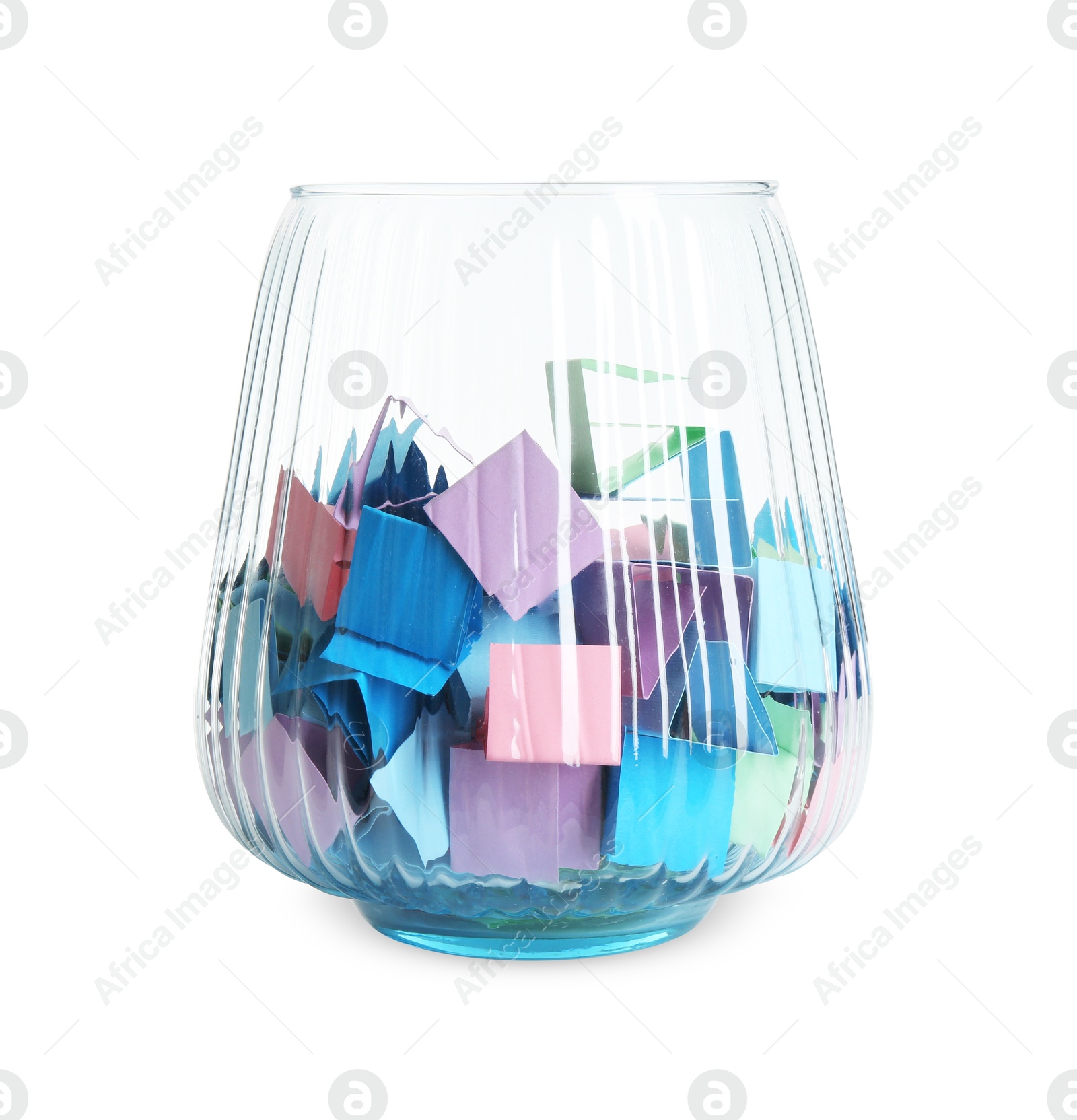 Many colorful paper pieces in glass isolated on white Photo of Many colorful paper pieces in glass isolated on white