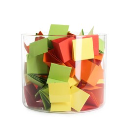 Photo of Many colorful paper pieces in glass isolated on white