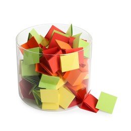 Photo of Many colorful paper pieces in glass isolated on white