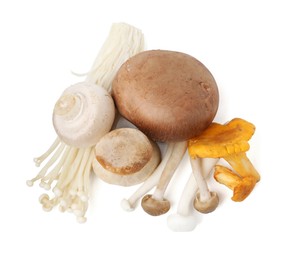 Photo of Different raw mushrooms isolated on white, top view