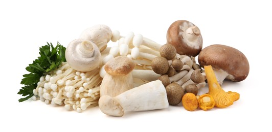 Photo of Different raw mushrooms and parsley isolated on white