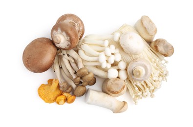 Photo of Different raw mushrooms isolated on white, top view
