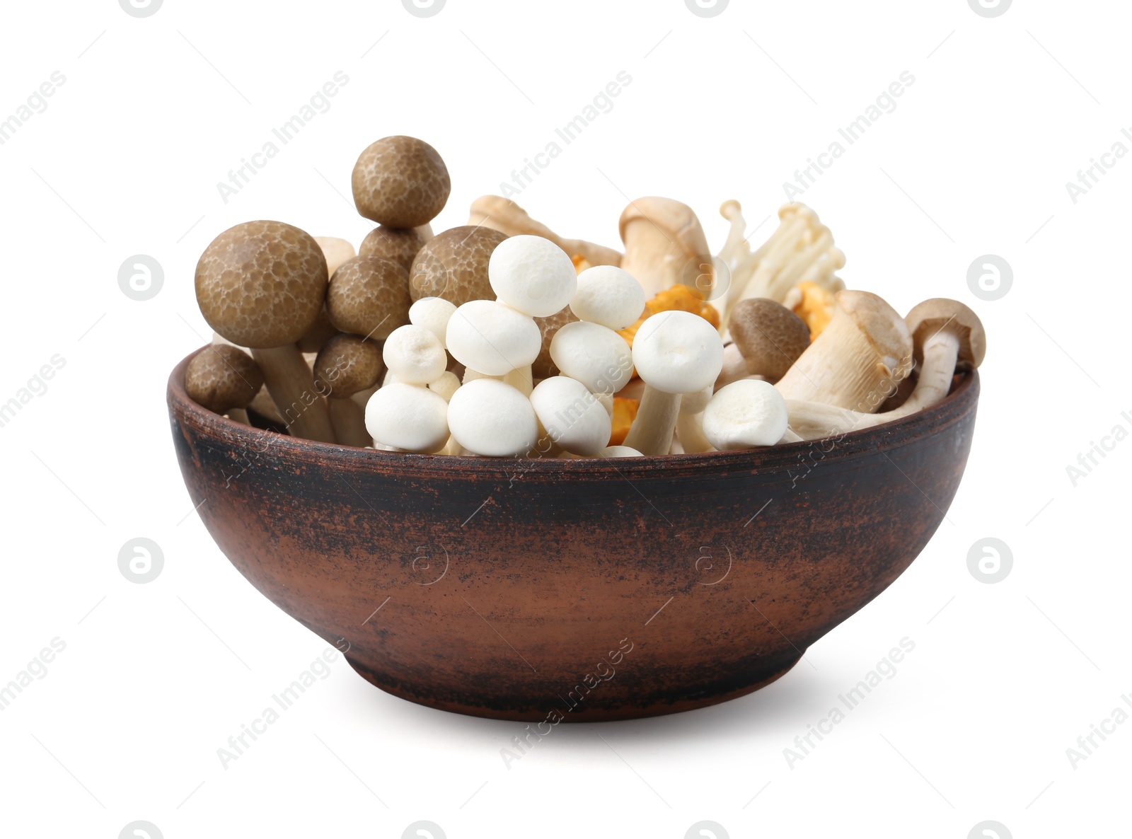 Photo of Different raw mushrooms in wooden bowl isolated on white