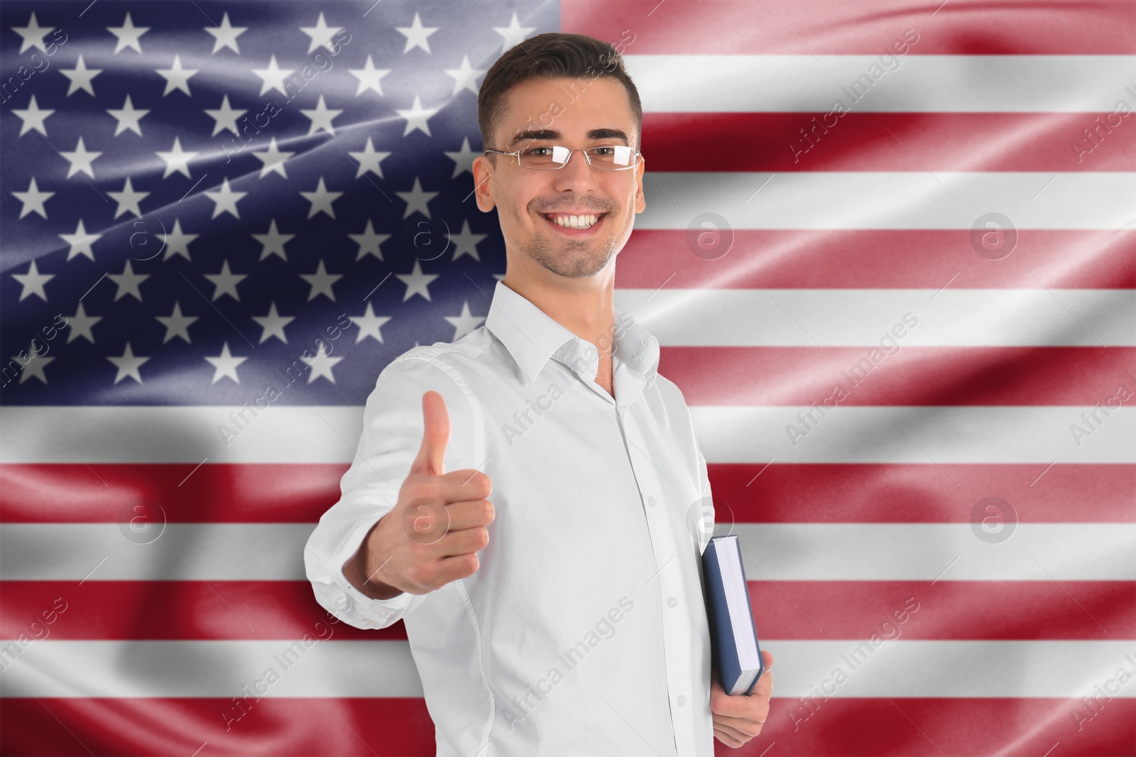 Teacher with book showing thumbs-up against flag of USA. Language school Image of Teacher with book showing thumbs-up against flag of USA. Language school