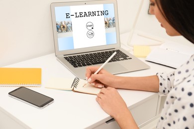 Image of E-learning concept. Woman studying online using laptop at desk, closeup