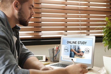 Image of Online study. Man using laptop for e-learning at desk
