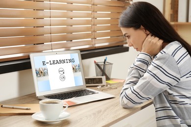 Image of E-learning concept. Woman studying online using laptop at desk