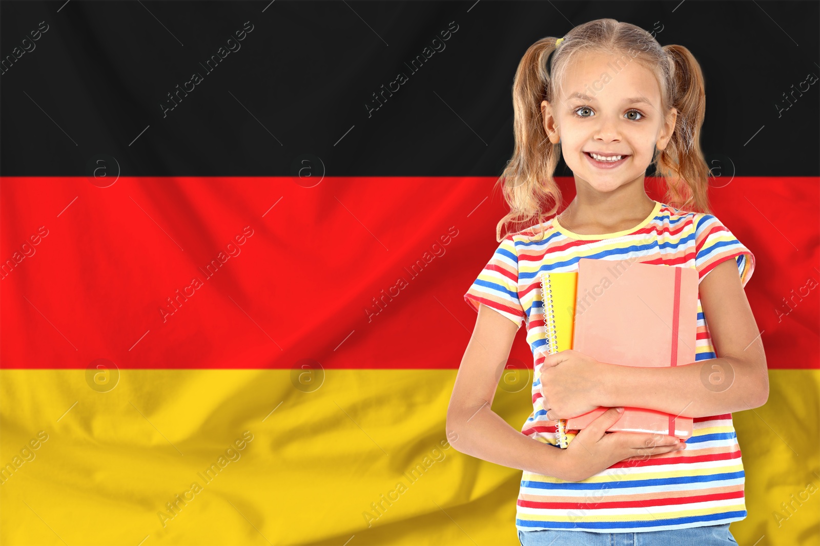 Little girl with notebooks against flag of Germany. Language school Image of Little girl with notebooks against flag of Germany. Language school