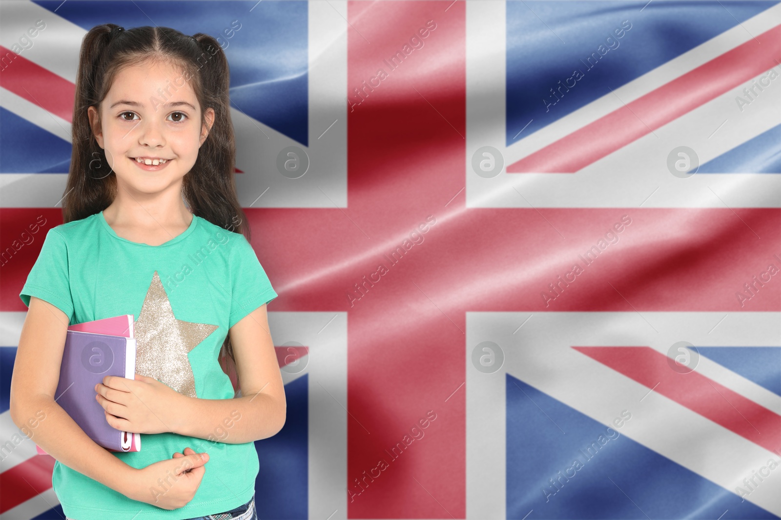Little girl with notebooks against flag of United Kingdom. Language school Image of Little girl with notebooks against flag of United Kingdom. Language school