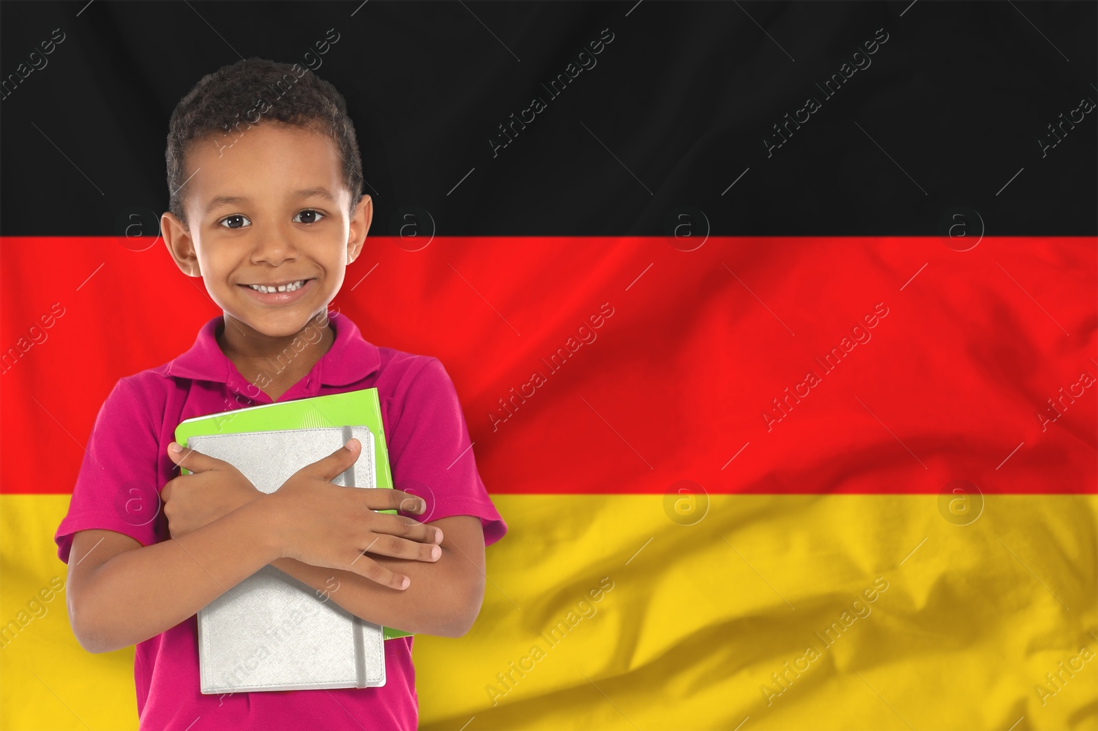 Little boy with notebooks against flag of Germany. Language school Image of Little boy with notebooks against flag of Germany. Language school