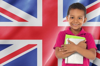 Image of Little boy with notebooks against flag of United Kingdom. Language school