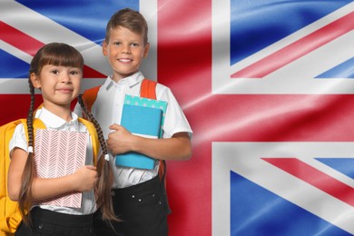 Image of Children with backpacks and notebooks against flag of United Kingdom. Language school