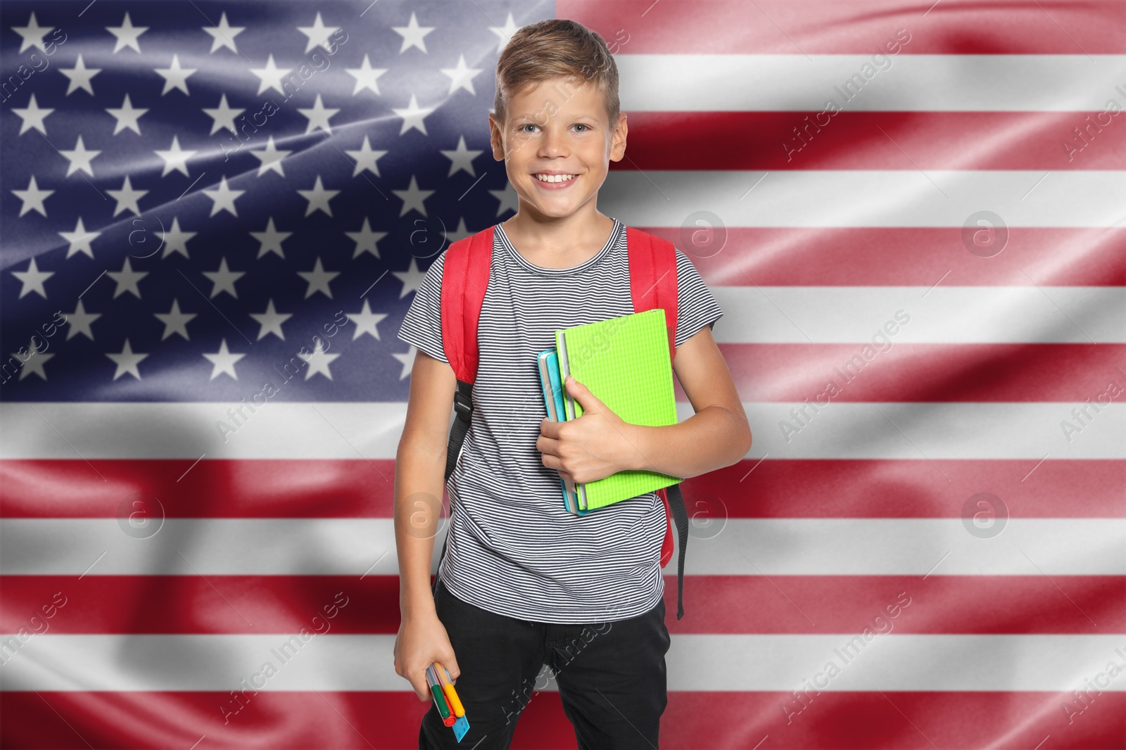 Little boy with backpack and stationery against flag of USA. Language school Image of Little boy with backpack and stationery against flag of USA. Language school