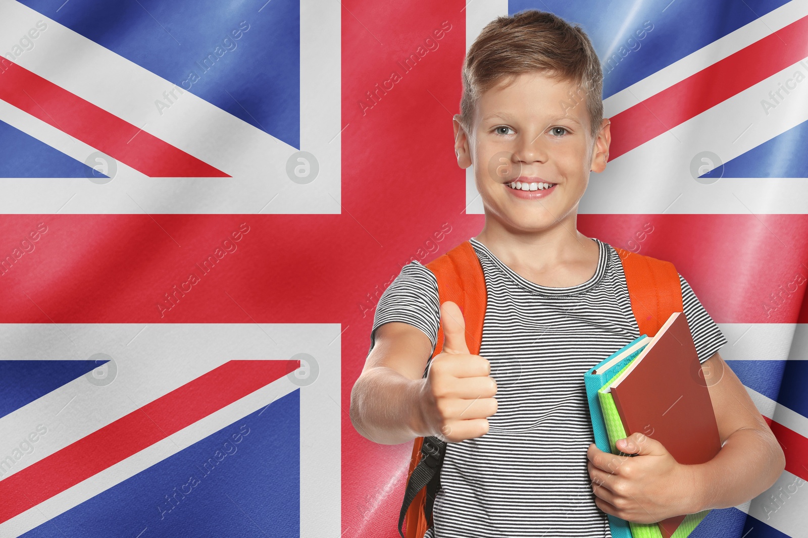 Little boy with backpack and notebooks showing thumbs-up against flag of United Kingdom. Language school Image of Little boy with backpack and notebooks showing thumbs-up against flag of United Kingdom. Language school