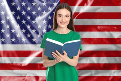 Image of Teacher or student with book against flag of USA. Language school