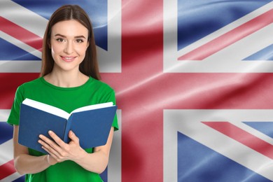 Image of Teacher or student with book against flag of United Kingdom. Language school