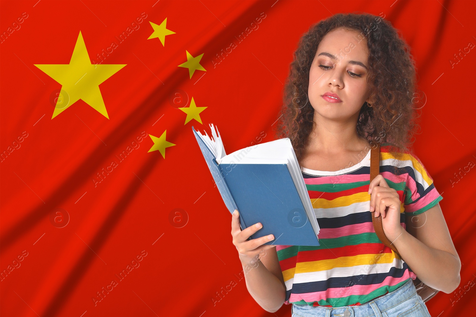 Student with book against flag of China. Language school Image of Student with book against flag of China. Language school