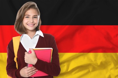 Image of Student with backpack and notebooks against flag of Germany. Language school
