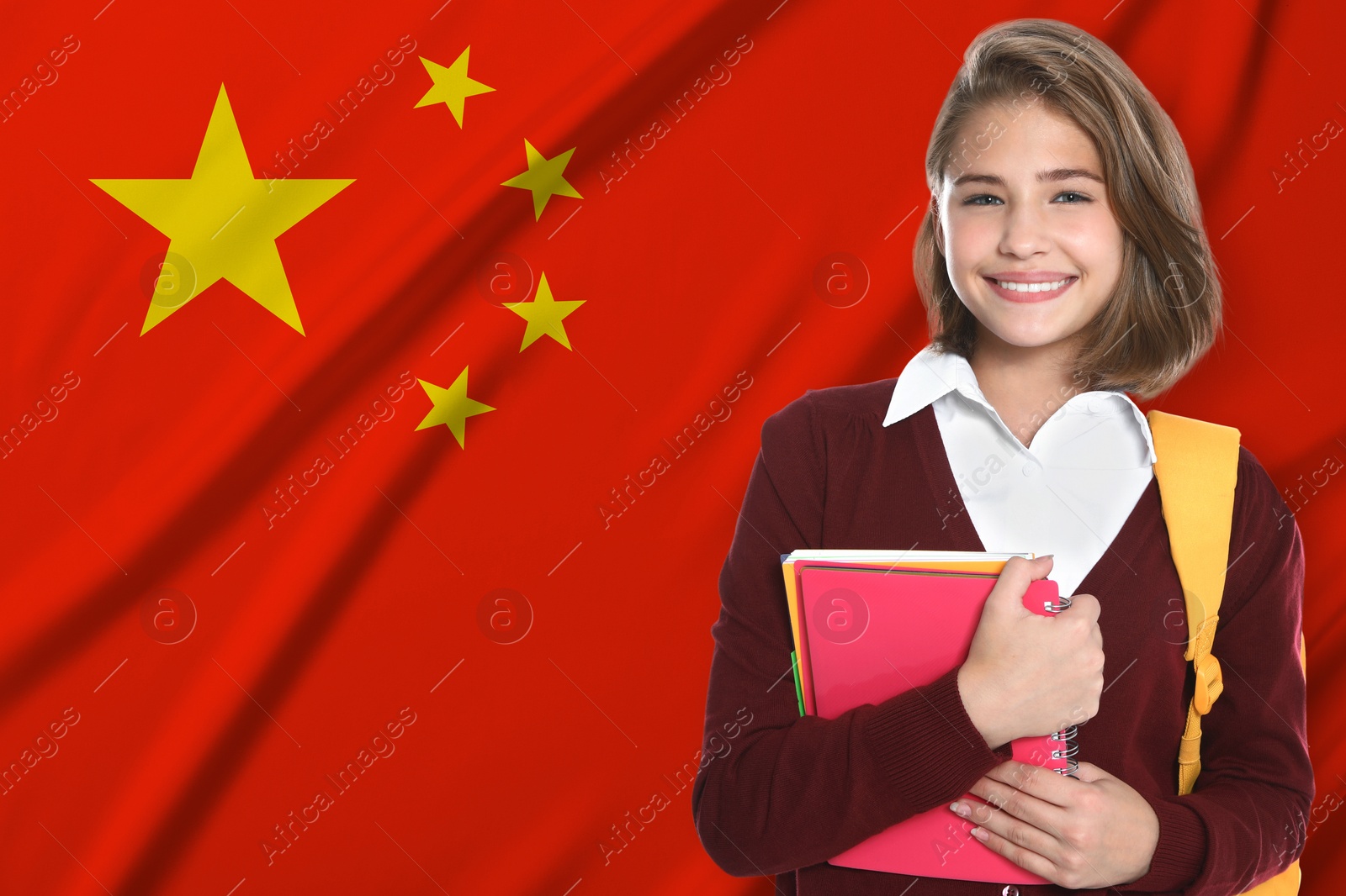 Student with backpack and notebooks against flag of China. Language school Image of Student with backpack and notebooks against flag of China. Language school