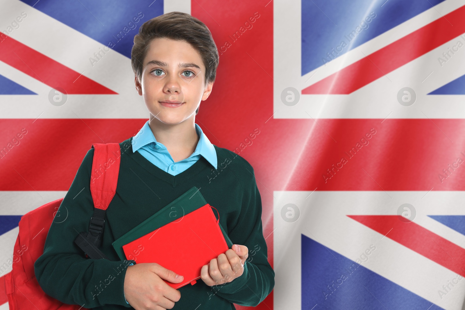 Student with backpack and notebooks against flag of United Kingdom. Language school Image of Student with backpack and notebooks against flag of United Kingdom. Language school