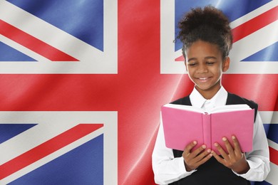 Image of Little girl with book against flag of United Kingdom. Language school
