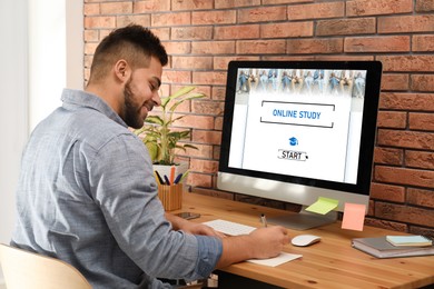 Image of Online study. Man using computer for e-learning at desk