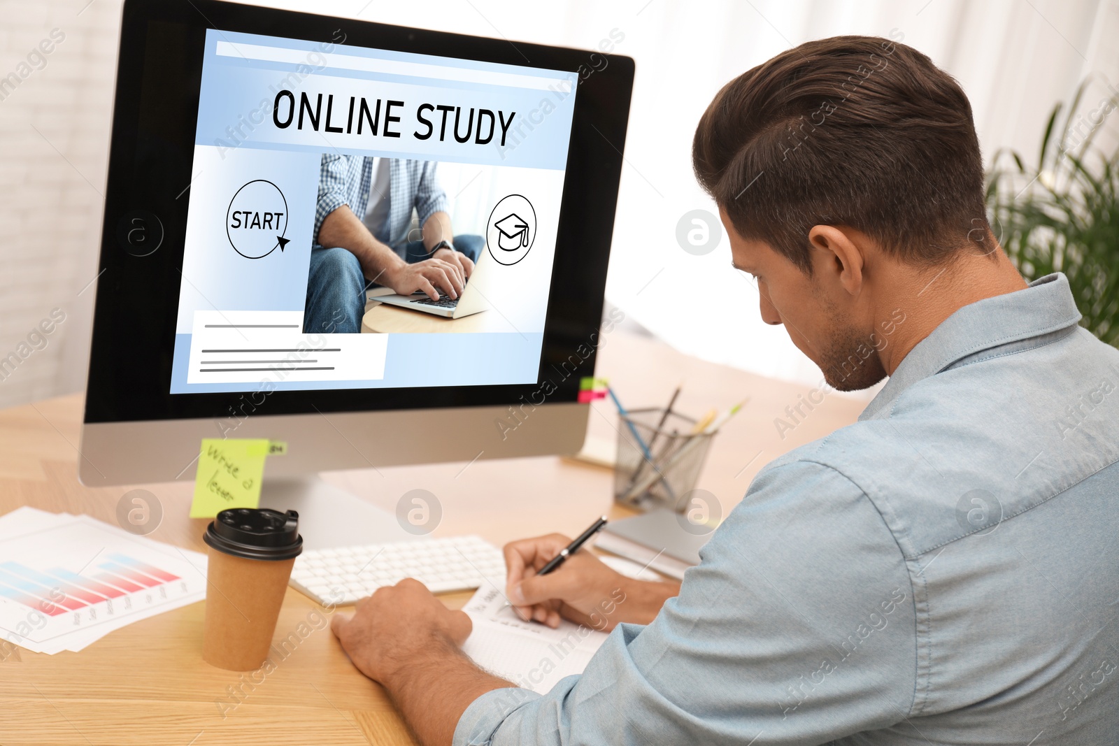 Image of Online study. Man using computer for e-learning at desk