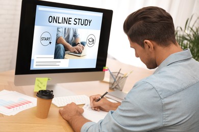 Image of Online study. Man using computer for e-learning at desk