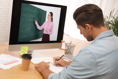 Image of E-learning concept. Student having online video chat with teacher via computer at desk