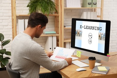 Image of E-learning concept. Man studying online using computer at desk