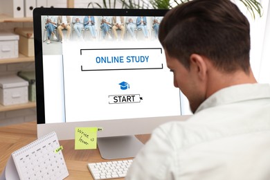 Image of Online study. Man using computer for e-learning at desk