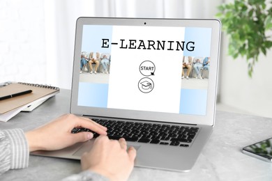 Image of E-learning concept. Woman studying online using laptop at desk, closeup