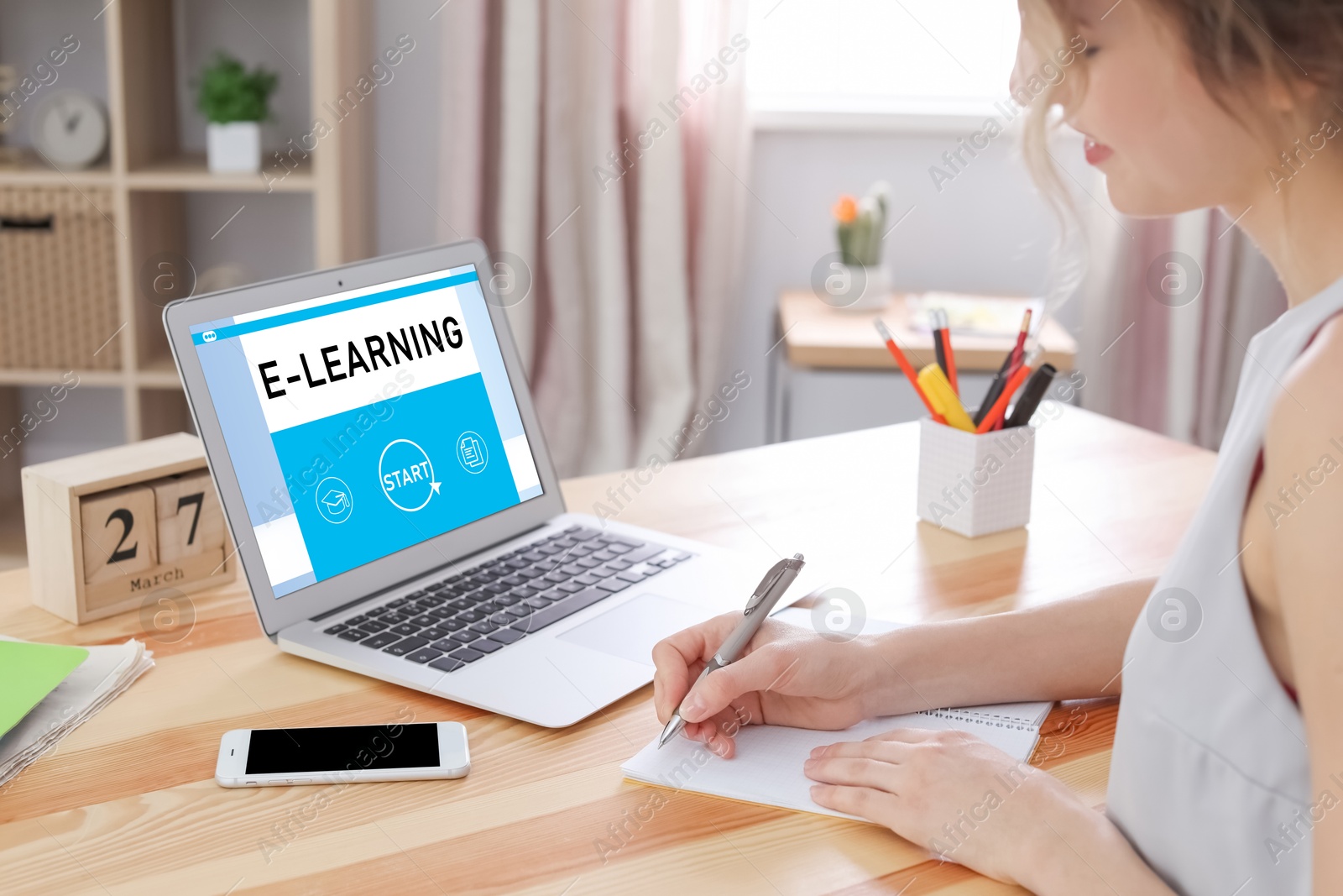 Image of E-learning concept. Woman studying online using laptop at desk, closeup