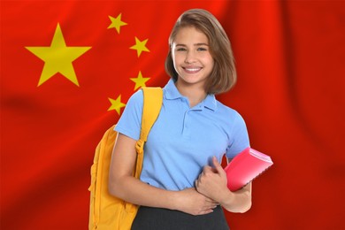 Image of Student with backpack and notebook against flag of China. Language school