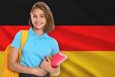 Image of Student with backpack and notebook against flag of Germany. Language school
